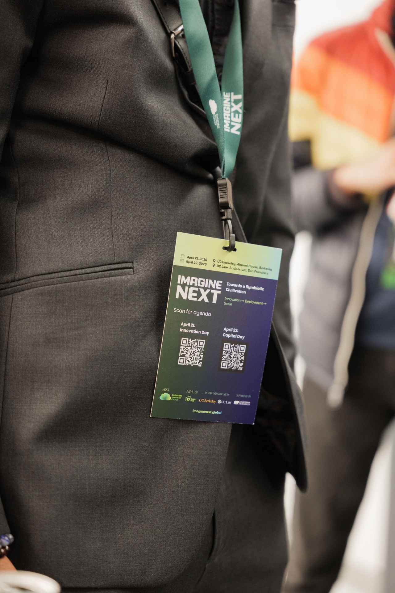Close-up of an Imagine Next delegate lanyard with QR codes for the Innovation Day and Capital Day agendas