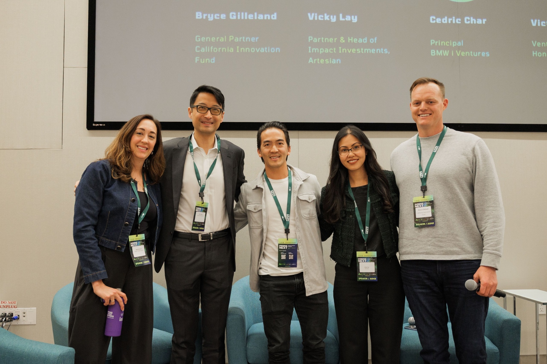 Capital Day VC panel group photo with Bryce Gilleland, Vicky Lay and Cedric Char beneath the speaker line-up slide at UC Law SF