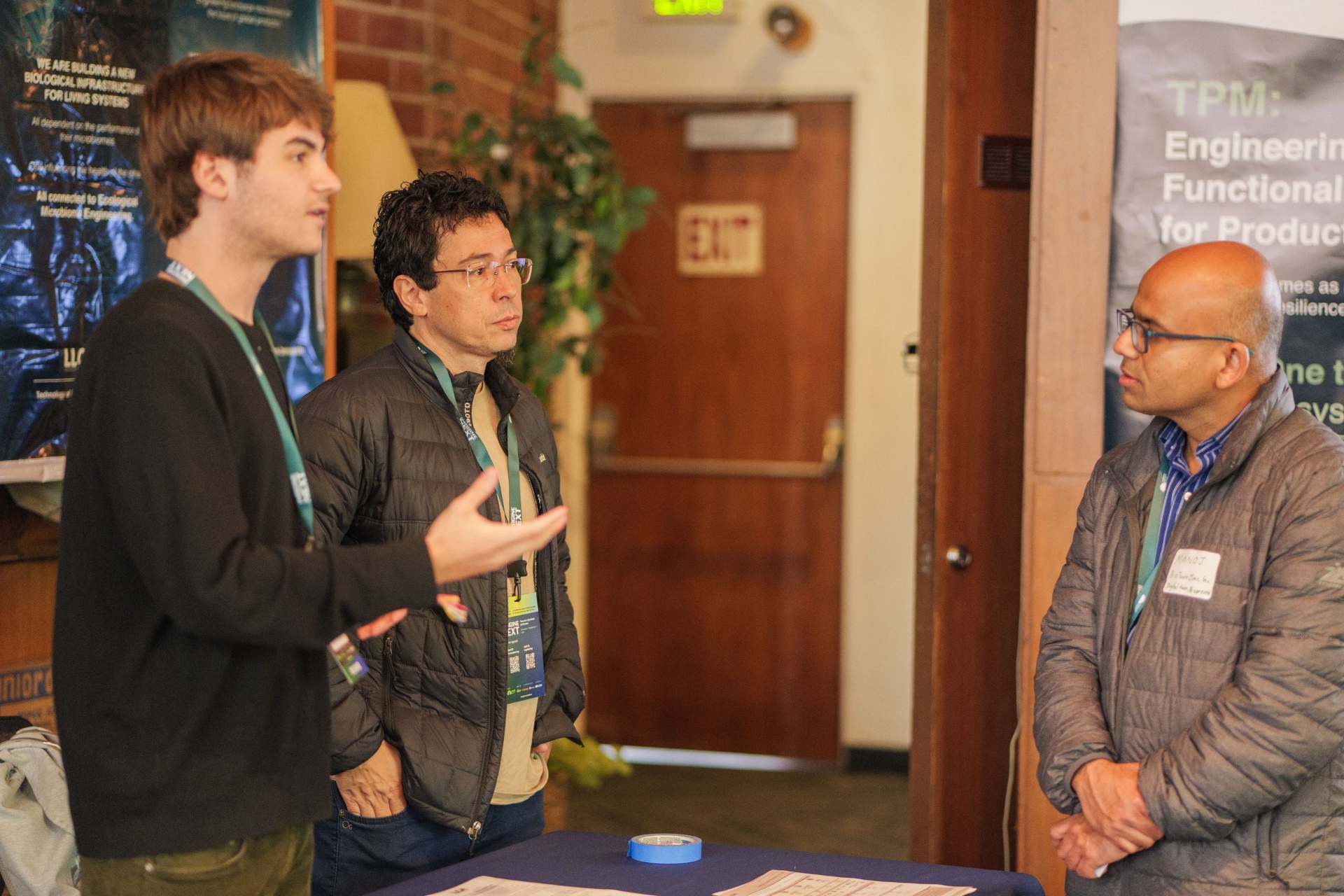 Three founders in technical discussion