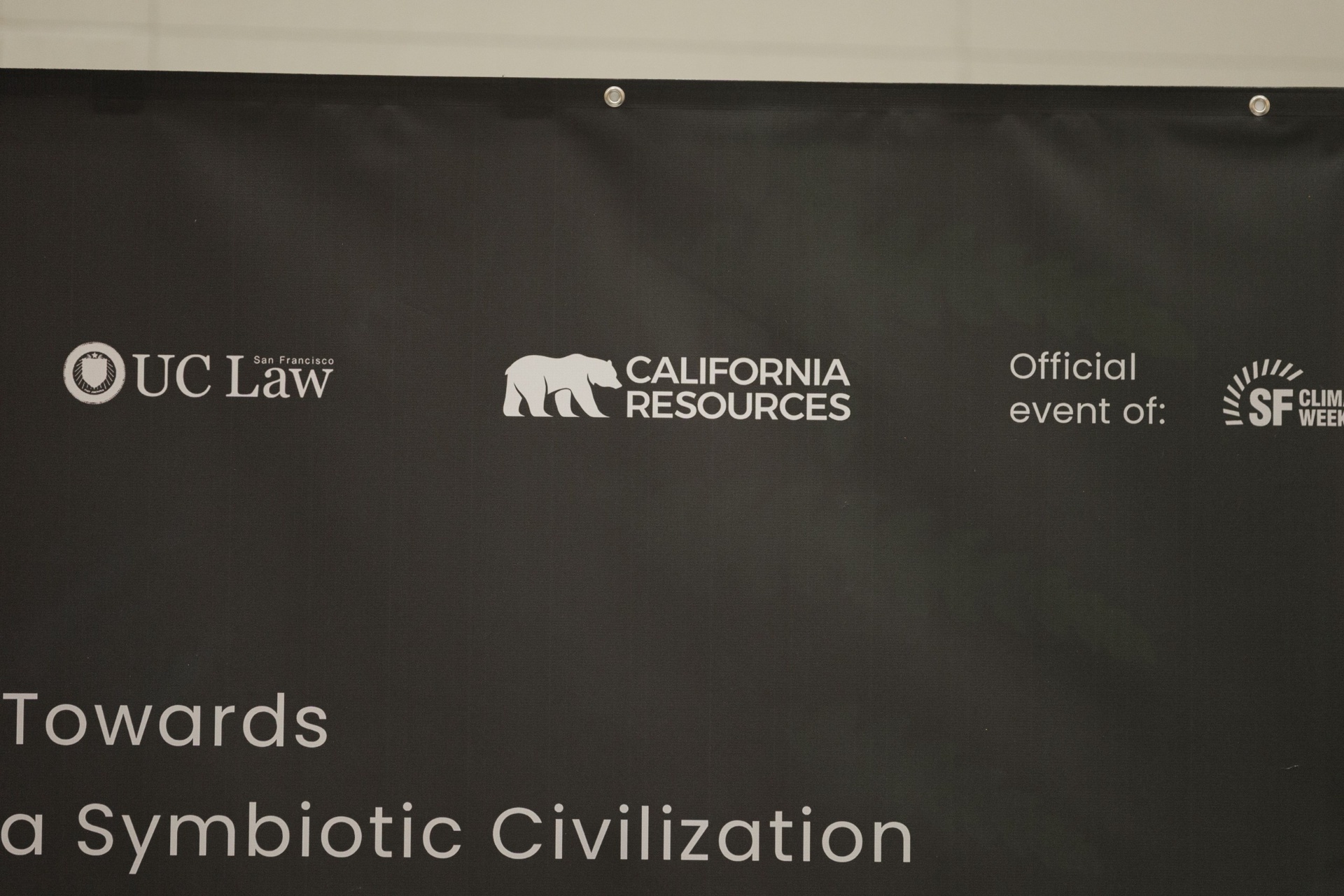 Imagine Next 'Towards a Symbiotic Civilization' Capital Day banner at UC Law SF featuring UC Law San Francisco, California Resources and SF Climate Week official event partner logos