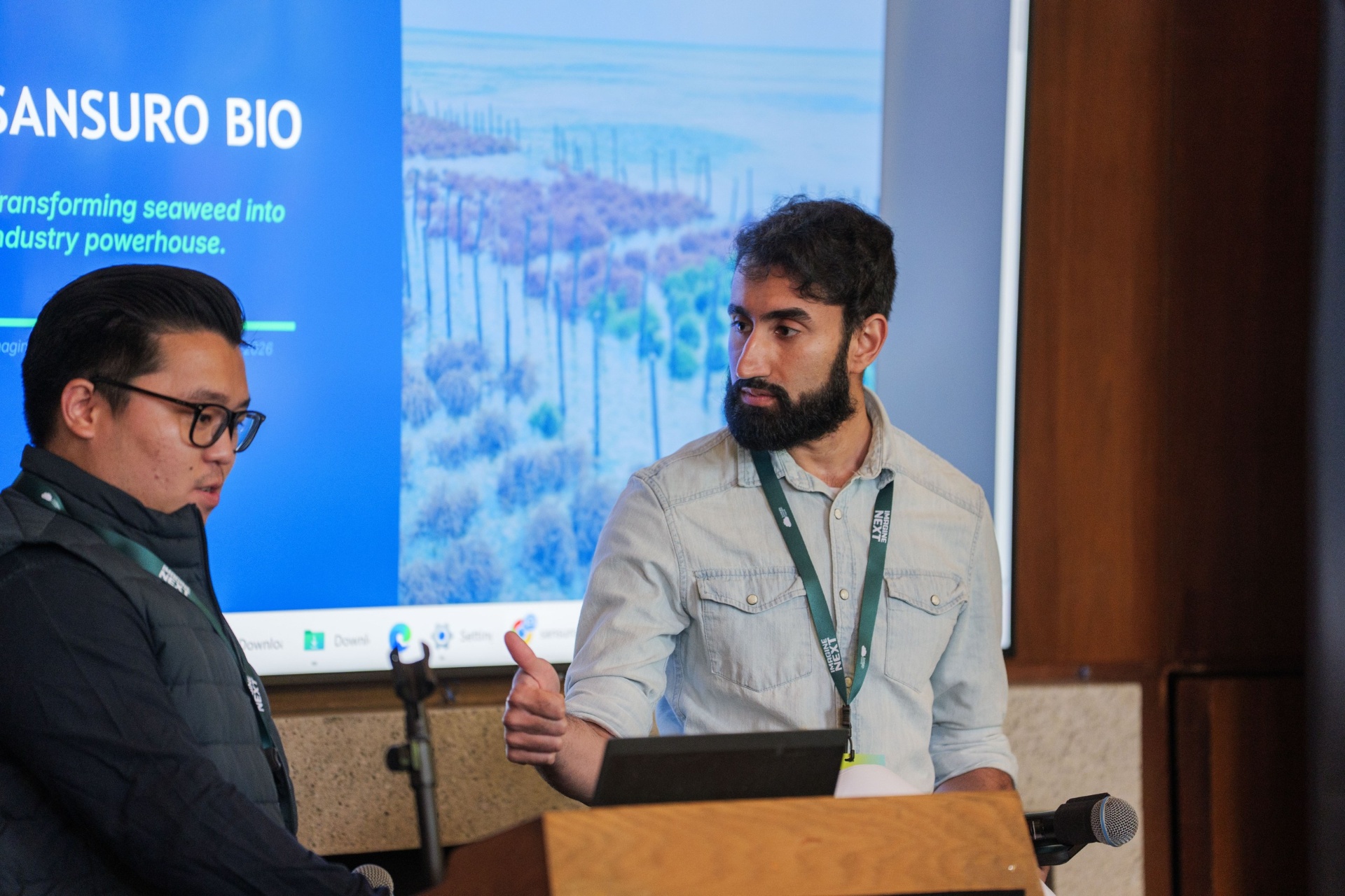 Sansuro Bio co-founders presenting on stage at the podium
