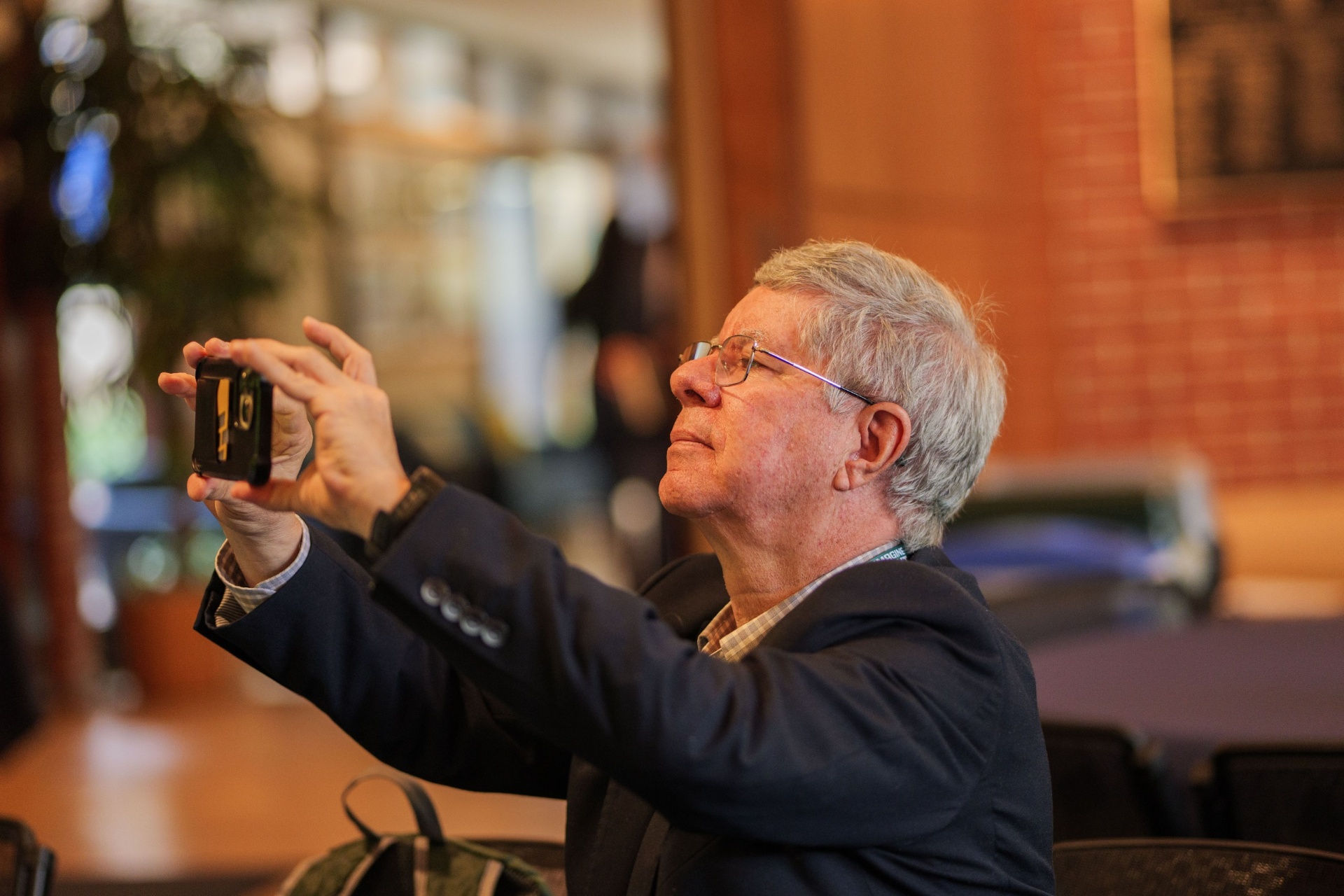 Attendee photographing the keynote moment