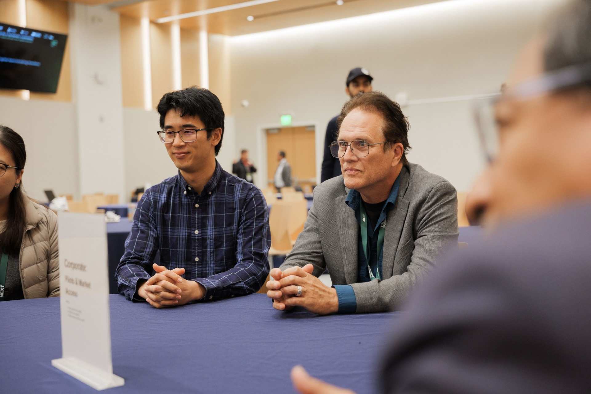 Capital Day Curated Capital Matchmaking Session — two delegates listening attentively at the 'Corporate: Pilots & Market Access' table at UC Law SF