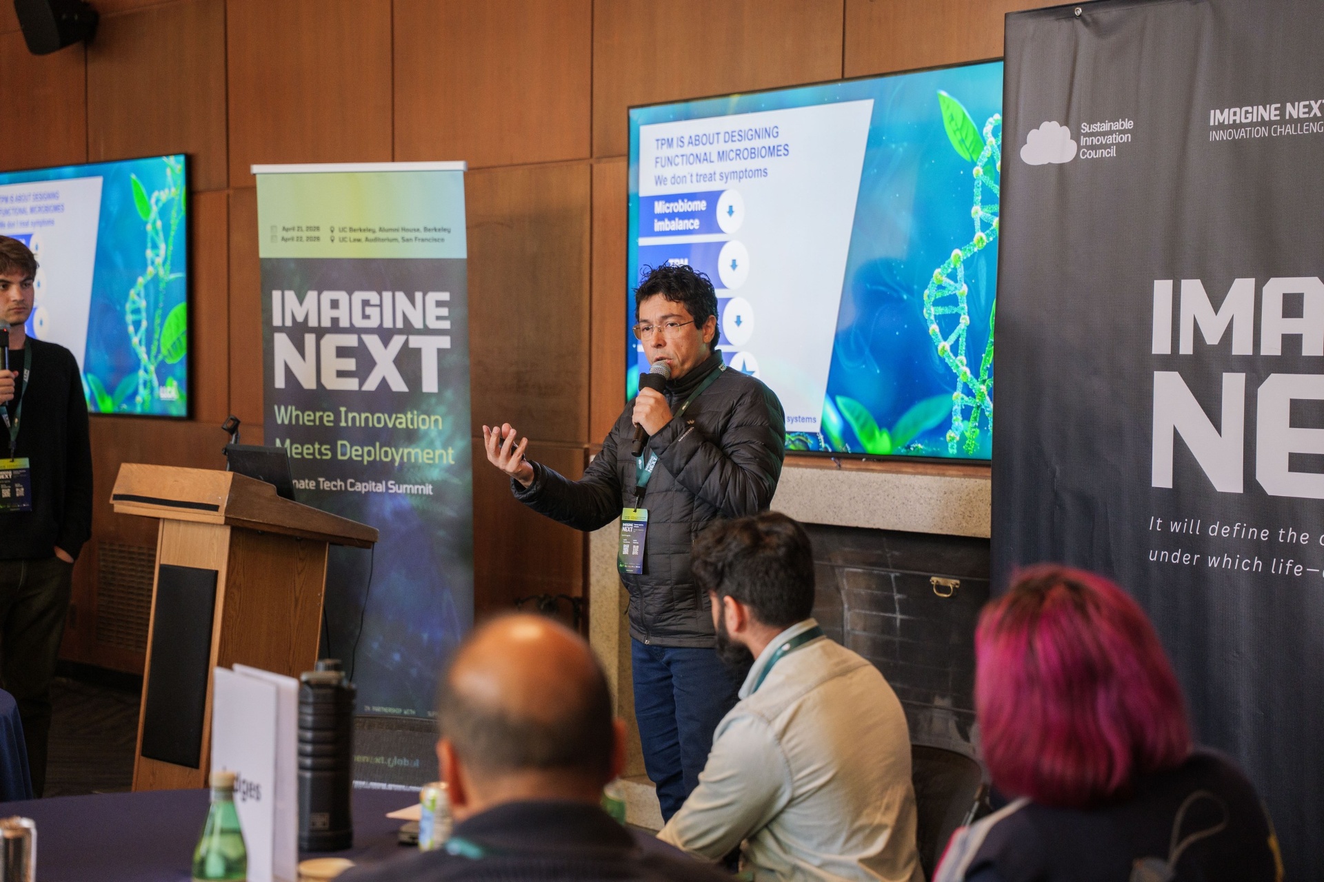 TPM presenter addressing the judges with microbiome slide on screen