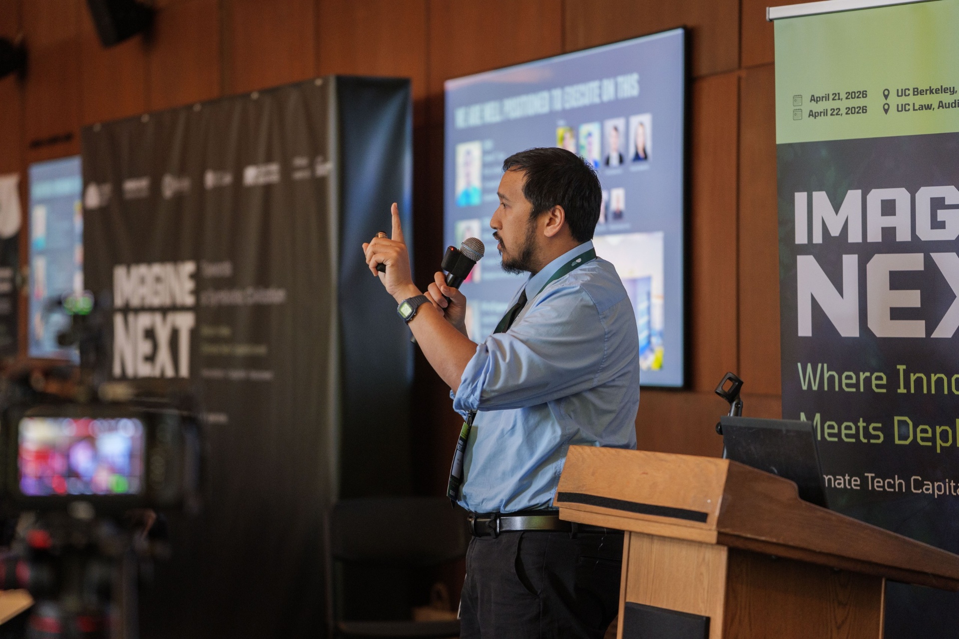 Presenter pointing while delivering pitch from the podium