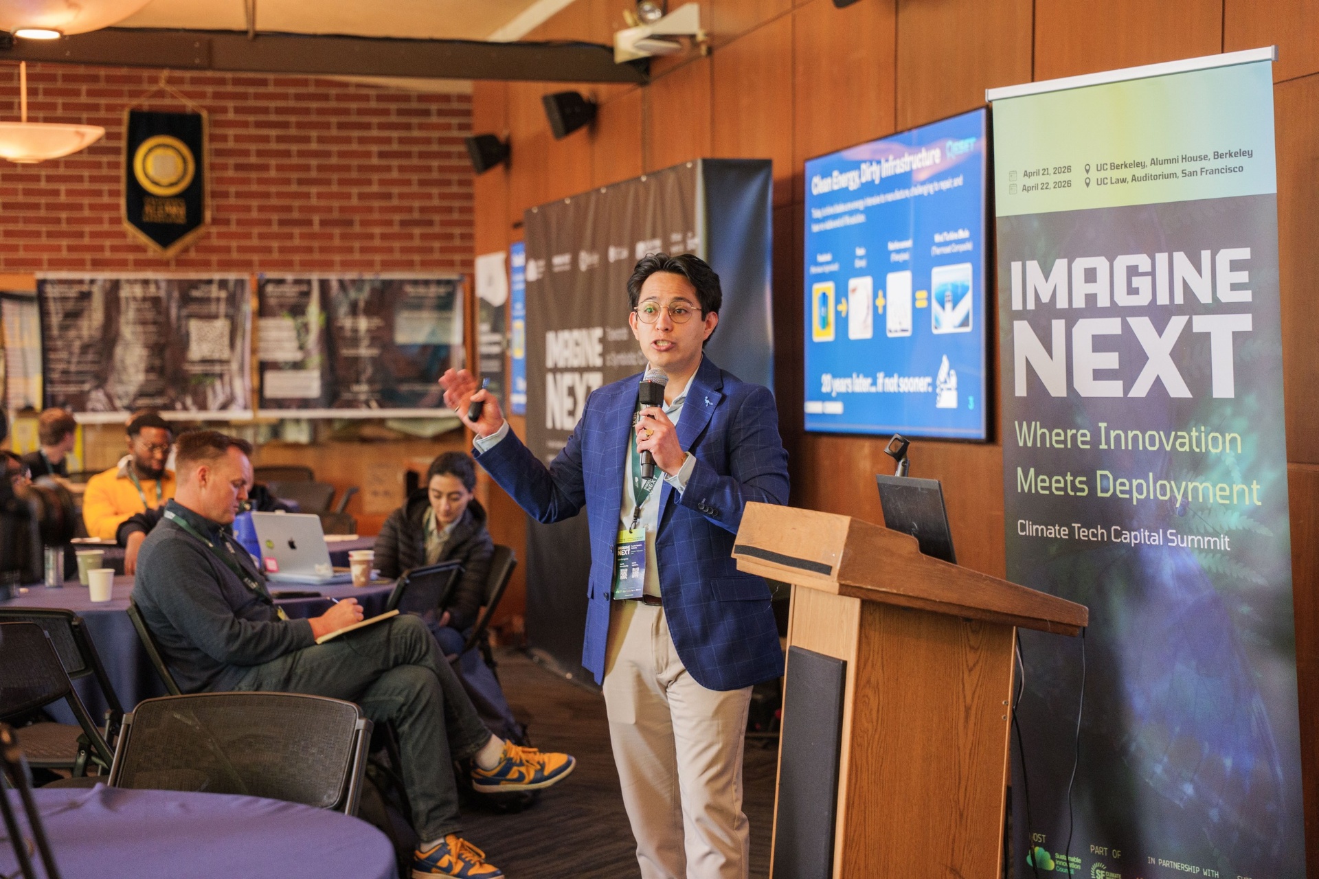 Edgar B. Mejia at the podium beside the Imagine Next banner