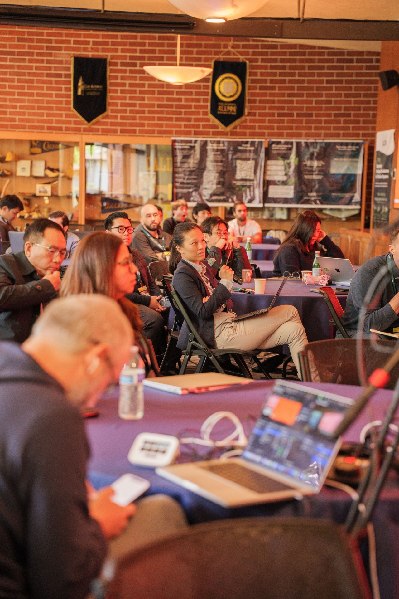 Delegate holding the microphone to ask a question during a pitch session