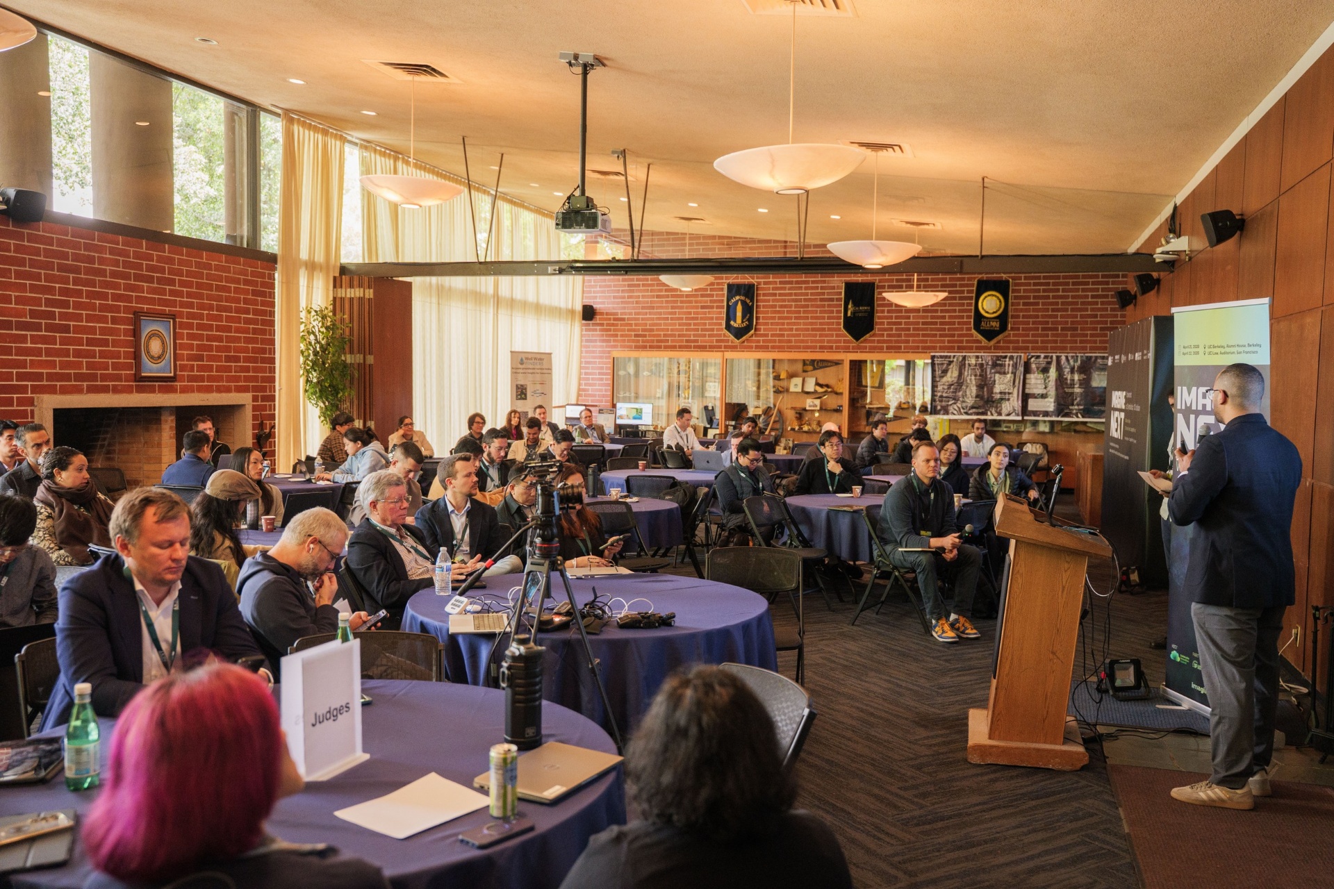 Wide view of the Alumni House room during a pitch session